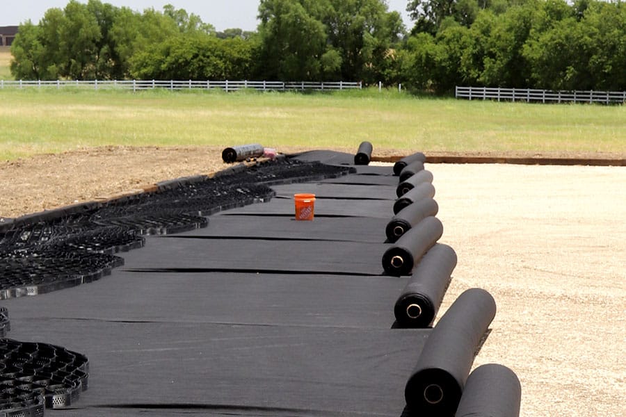 RP6 6oz non-woven geotextile being rolled out under RootPro surface cell