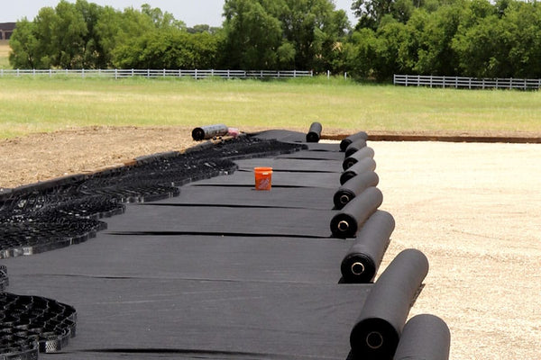 RP6 6oz non-woven geotextile being rolled out under RootPro surface cell
